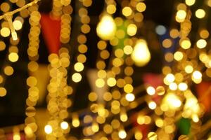 Blurred and bokeh of LED party lights and refection lighting on night time background photo