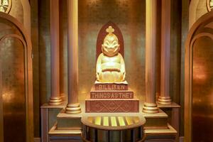 Osaka City, JP, 2019 - Wooden Japanese baby god Billiken Enshrined on the 5th floor of the Tsutenkaku tower. Billiken is a charm doll and popular symbol of happiness, good luck of Osaka. photo