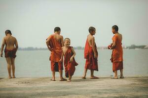 PATTAYA THAILAND - APRIL16,2018  unidentified group of buddhist novice playing with happiness emotion in thai buddhist temple ,most of thai boy must be a novice once time in a life photo