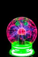 a glowing green and pink light bulb on a stand photo