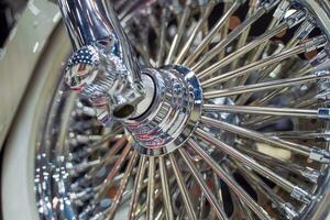 Closeup and crop front wheel of Chopper motorbike with chrome colors. photo