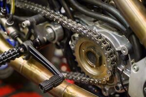 Closeup and crop motorcycle engine drive system with chains and sprockets photo