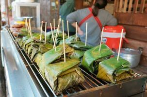 Local food in northern Thailand Made with minced pork and coconut milk wrapped in banana leaves  grilled on the stove. photo