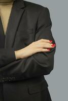 Business lady keeps her hands folded. Red manicure. photo