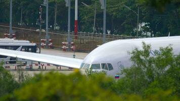 PHUKET, THAILAND NOVEMBER 28, 2019 Medium shot of an Aeroflot plane on the runway at Phuket airport, Thailand video