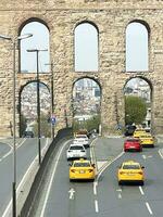 15 of April 2023 - Istanbul, Turkey - The Valens Aqueduct is part of the water supply system of Constantinople. Located in the old part of Istanbul on Ataturk Boulevard. photo