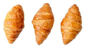 Top view of three separated fresh croissants in set isolated on white background with clipping path photo