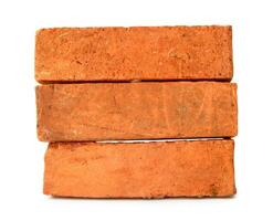 Cracked old red or orange bricks in stack isolated on white background with clipping path photo