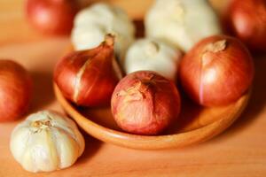 onion and garlic on a wooden background. Selective focus. photo