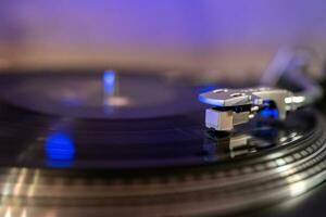 Closeup of Vinyl Record Player Turntable with Needle on the Record photo