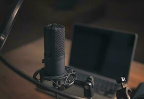 Interior of a home studio for podcasts. Large Microphone, notebook and notebooks on table. Interior. Closeup photo