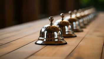 Row of Polished Service Bells on Wooden Table. AI Generated. photo