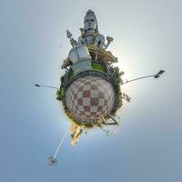 tallest hindu shiva statue in india on mountain near ocean on little planet in blue sky, transformation of spherical 360 panorama. Spherical abstract view with curvature of space. photo
