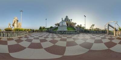 full 360 hdri panorama near tallest hindu shiva statue in india on mountain near ocean in equirectangular projection photo
