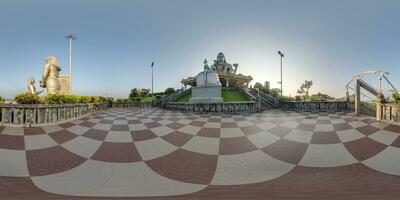 full 360 hdri panorama near tallest hindu shiva statue in india on mountain near ocean in equirectangular projection photo