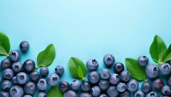 Fresh blueberries with green leaves on a blue background. AI Generated. photo