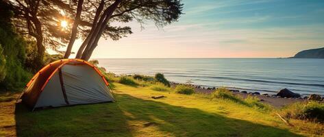 Camping tent and camping equipment on green grass with sea view background AI generated photo