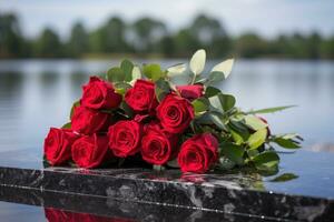 Red roses on black granite tombstone in the park, funeral concept AI generated photo