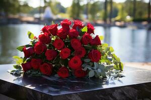 Red roses on black granite tombstone in the park, funeral concept AI generated photo