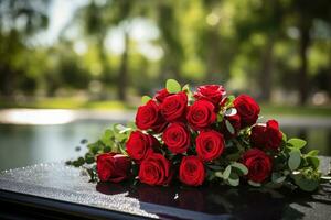 Red roses on black granite tombstone in the park, funeral concept AI generated photo