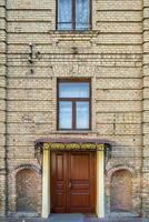 windows with decorative elements on an old wooden or brick building photo