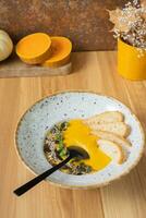 A plate of mashed pumpkin soup on wooden table. Autumn menu concept photo