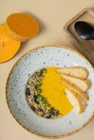 A plate of mashed pumpkin soup top view, flat lay. Autumn menu concept photo