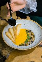 Pumpkin puree soup on a waiter's tray. The concept of the restaurant's autumn menu photo