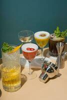 Composition with alcoholic cocktails and bar tools on podiums on colored background. photo