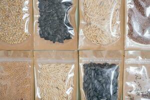 Set for growing sprouts from seeds. Sunflower, flax, wheat seeds lay flat, top view photo