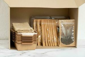 Set for growing sprouts from seeds. Open box with seeds, linen mats,containers and lids. photo
