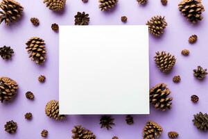 Creative frame made of Christmas pine cones with square Paper blank. Xmas and New Year theme. Flat lay, top view copy space photo