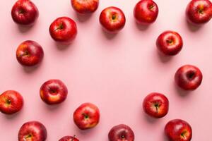 Many red apples on colored background, top view. Autumn pattern with fresh apple above view with copy space for design or text photo