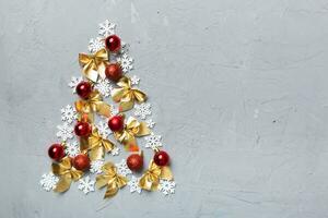 Christmas tree made from colored ball decoration on colored background, view from above. New Year minimal concept with copy space photo