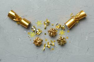 Christmas crackers with shiny confetti on color background, top view, copy space photo