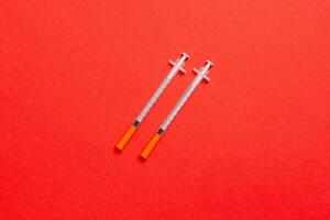 Top view of insulin syringes ready for injection on colorful background. Diabetic concept with copy space photo