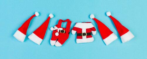 Top view of colorful holiday background Banner made of Santa hats and clothes. Merry Christmas concept with copy space photo