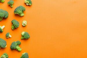 Top view fresh green broccoli vegetable on Colored background. Broccoli cabbage head Healthy or vegetarian food concept. Flat lay. Copy space photo