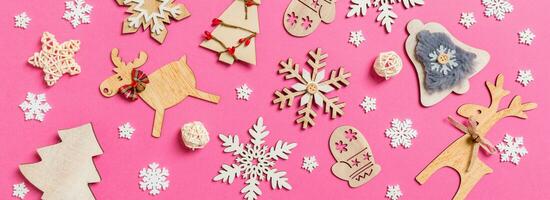 Top view Banner of holiday decorations and toys on pink background. Christmas ornament concept photo