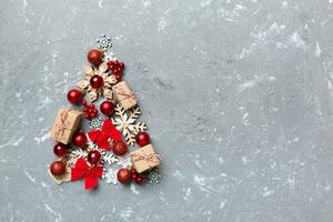 Christmas tree made from colored ball decoration on colored background, view from above. New Year minimal concept with copy space photo