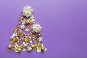 Christmas tree made from colored ball decoration on colored background, view from above. New Year minimal concept with copy space photo