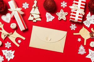 Top view of envelope on red background. New Year decorations. Christmas holiday concept photo