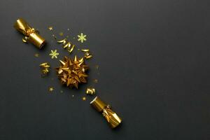 Christmas crackers with shiny confetti on color background, top view, copy space photo