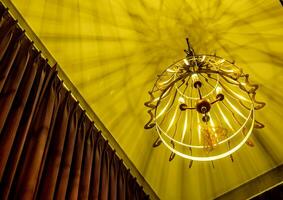 Warm colored light from a modern ceiling pendant lamp photo