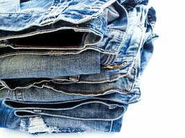 Pile of blue jeans, fabric texture photo