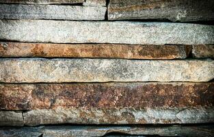 Part of a stone fence. Selective focus. photo