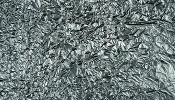 Crumpled silver foil sheet. Abstract background. Banner. Top view. Selective focus. photo