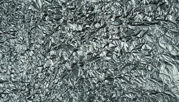 Crumpled silver foil sheet. Abstract background. Banner. Top view. Selective focus. photo