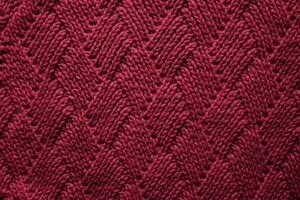 Knitted wool texture colored in the color of the Year 2023 Viva Magenta 18-1750. Wallpaper. Banner. Close-up. Selective focus. photo