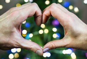 Hands of a man and a woman in the shape of a heart. Close-up. Selective focus. photo